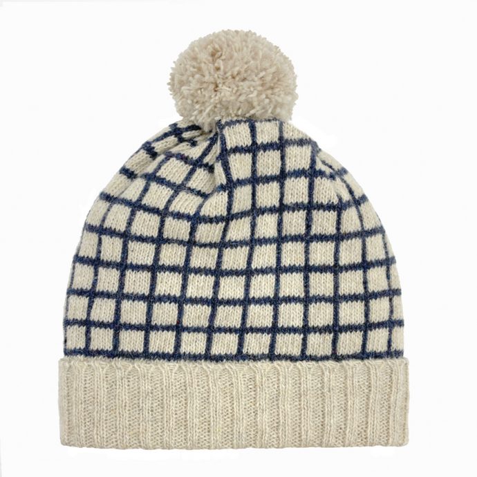 Recycled wool cream coloured beanie with dark blue grid pattern and cream pom pom